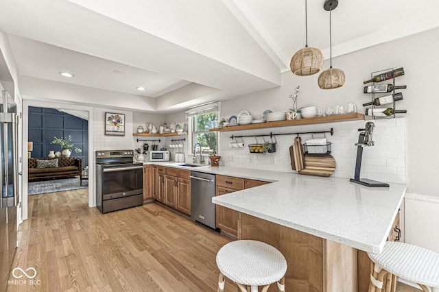 11329 Moss Dr, Carmel, IN 46033 - kitchen with appliances with stainless steel finishes, open shelves, a peninsula, light wood-style flooring, and backsplash