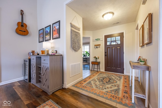 12854 Longleaf Ln, Fishers, IN 46038 - entrance foyer featuring a textured ceiling and dark wood finished floors
