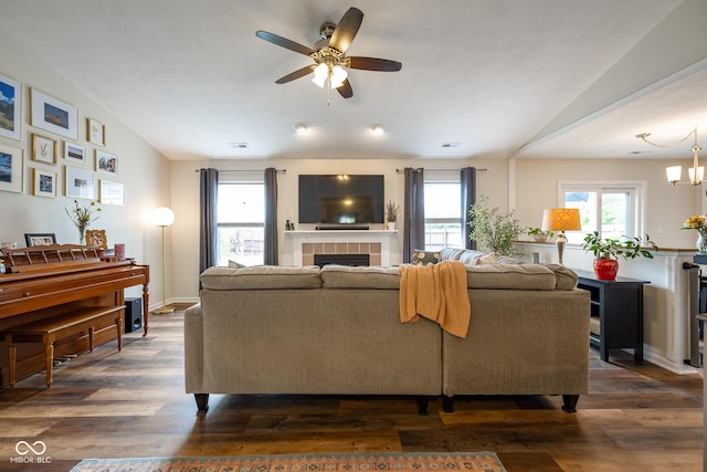 12854 Longleaf Ln, Fishers, IN 46038 - living area featuring vaulted ceiling, a ceiling fan, dark wood finished floors, healthy amount of natural light, and a tile fireplace