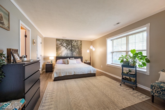 12854 Longleaf Ln, Fishers, IN 46038 - bedroom with wood finished floors, a textured ceiling, and crown molding