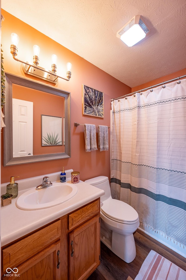 12854 Longleaf Ln, Fishers, IN 46038 - full bathroom featuring wood finished floors, vanity, and a textured ceiling