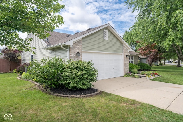 12854 Longleaf Ln, Fishers, IN 46038 - view of home's exterior with a garage, driveway, a lawn, and a shingled roof