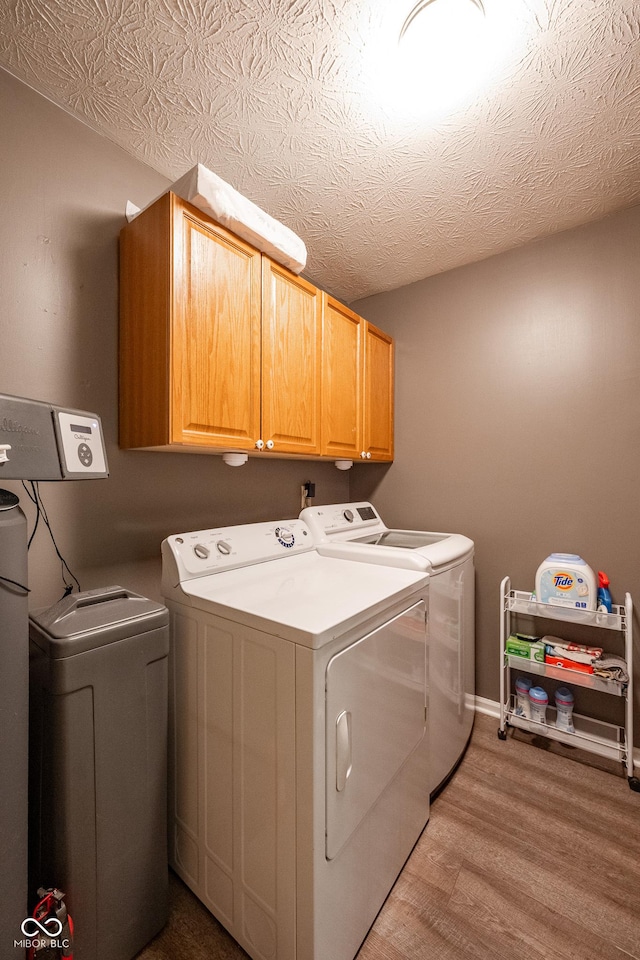 12854 Longleaf Ln, Fishers, IN 46038 - washroom featuring cabinet space, independent washer and dryer, and wood finished floors