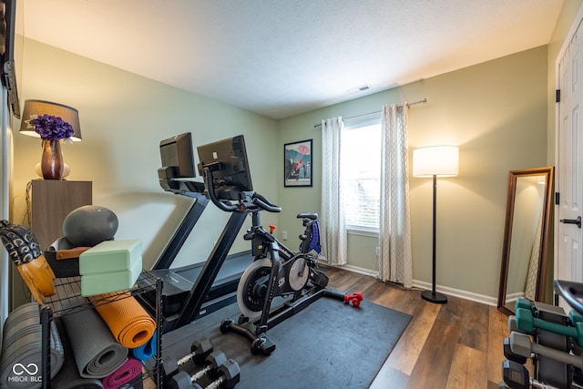 12854 Longleaf Ln, Fishers, IN 46038 - exercise room with wood finished floors and baseboards