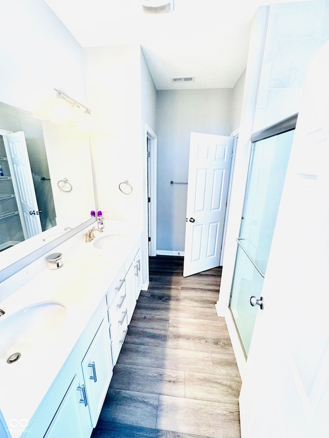 4732 Bethel Creek Blvd, Indianapolis, IN 46239 - bathroom featuring a stall shower, double vanity, and wood finished floors