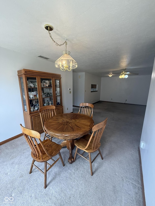 1338 Swan Dr, Franklin, IN 46131 - carpeted dining room featuring a chandelier, ceiling fan, and a textured ceiling