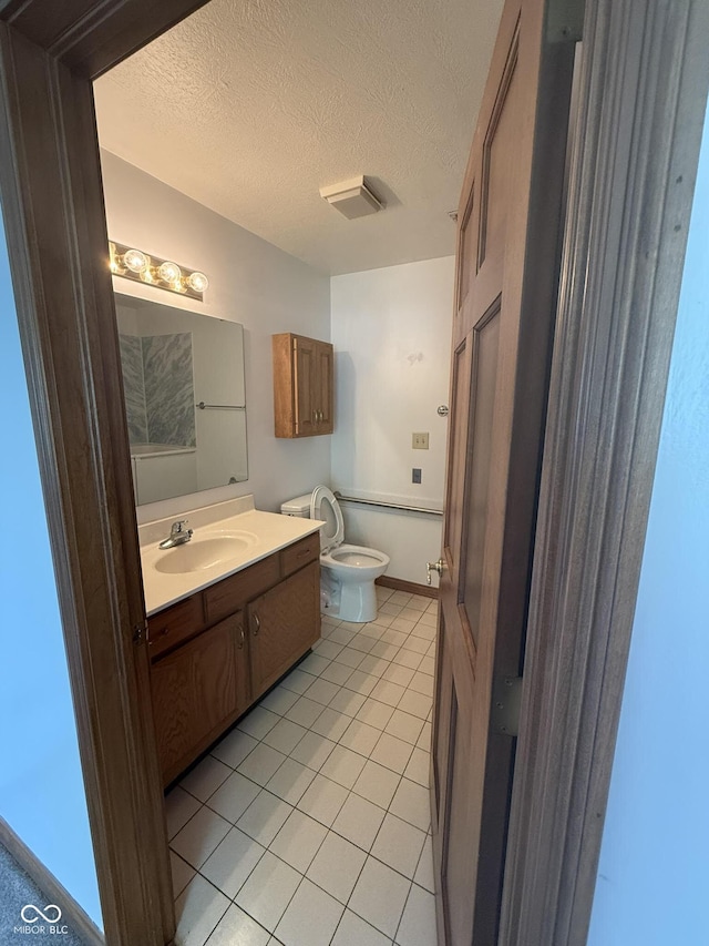 1338 Swan Dr, Franklin, IN 46131 - half bath with vanity, tile patterned floors, and a textured ceiling
