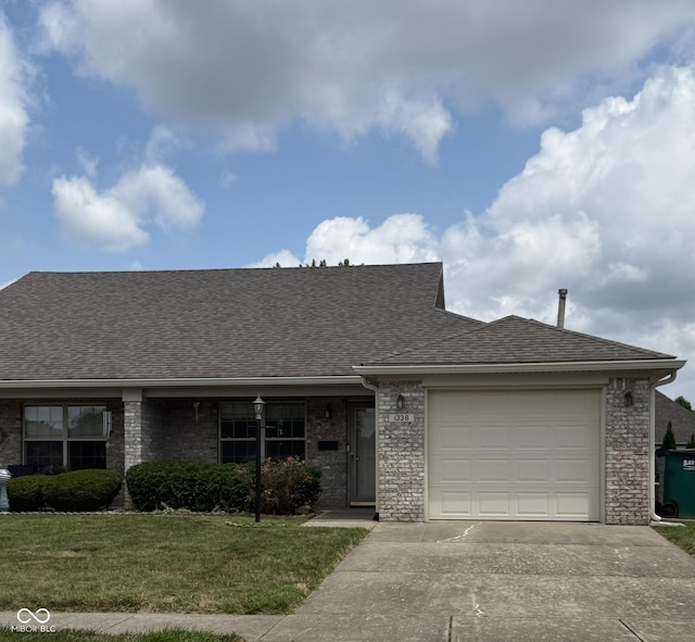 1338 Swan Dr, Franklin, IN 46131 - view of front of house with roof with shingles, a garage, a front yard, concrete driveway, and brick siding