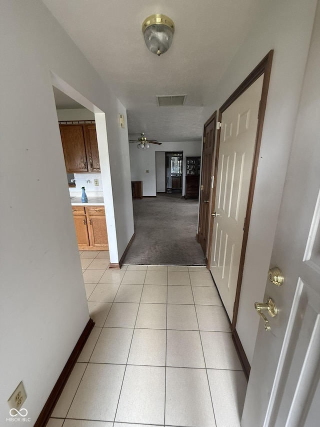 1338 Swan Dr, Franklin, IN 46131 - hallway with light colored carpet and light tile patterned flooring