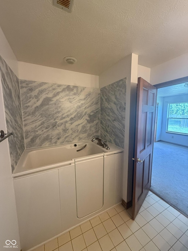1338 Swan Dr, Franklin, IN 46131 - bathroom featuring a bath, a textured ceiling, and tile patterned flooring
