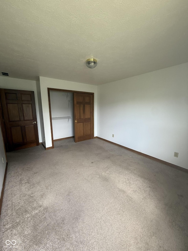 1338 Swan Dr, Franklin, IN 46131 - unfurnished bedroom with a closet, light carpet, and a textured ceiling