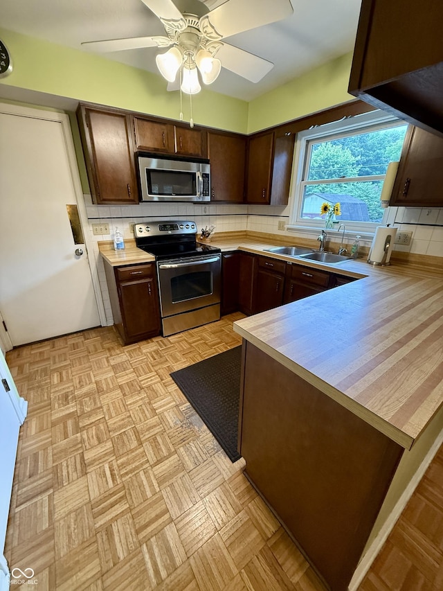 511 Canterbury Ct, Noblesville, IN 46060 - kitchen featuring stainless steel appliances, dark brown cabinets, light countertops, and backsplash