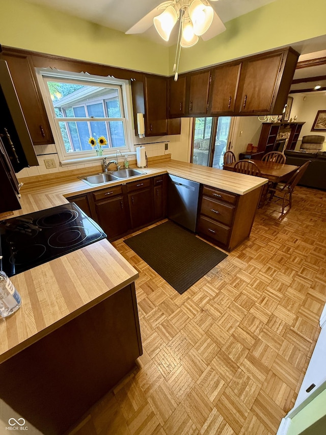 511 Canterbury Ct, Noblesville, IN 46060 - kitchen with stainless steel dishwasher, dark brown cabinetry, a peninsula, ceiling fan, and stove