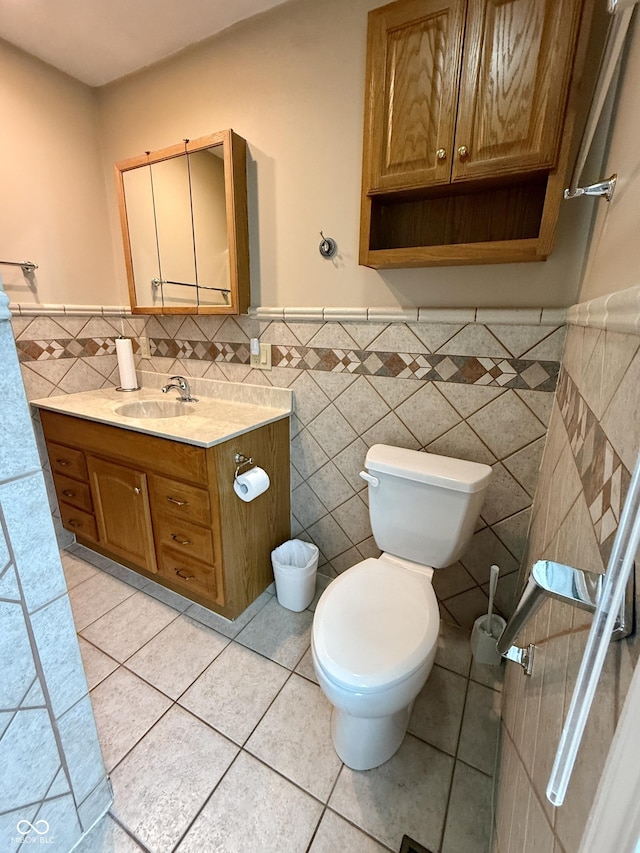 511 Canterbury Ct, Noblesville, IN 46060 - bathroom with tile walls, vanity, tile patterned flooring, and a wainscoted wall