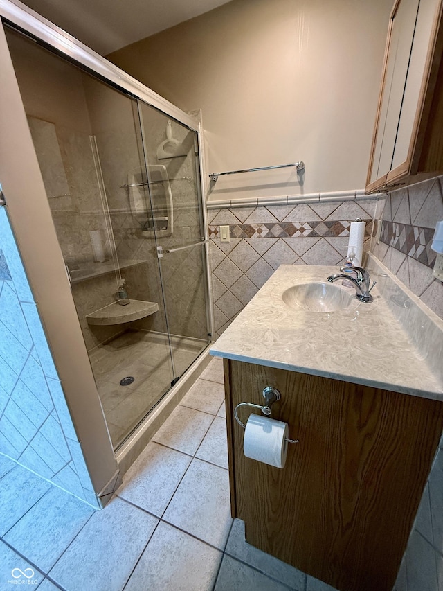 511 Canterbury Ct, Noblesville, IN 46060 - bathroom with tile patterned floors, vanity, a shower stall, tile walls, and wainscoting