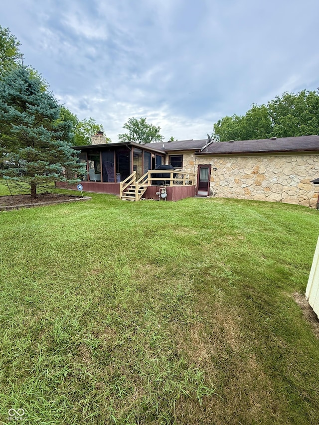 511 Canterbury Ct, Noblesville, IN 46060 - rear view of house featuring a sunroom, stone siding, a yard, and a chimney