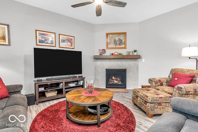9470 Tobin Cir, Avon, IN 46123 - living room featuring wood finished floors, ceiling fan, and a tiled fireplace