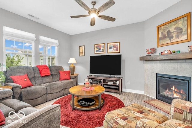 9470 Tobin Cir, Avon, IN 46123 - living area featuring wood finished floors, a ceiling fan, and a tiled fireplace