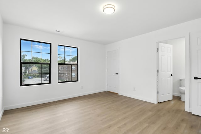 3455 N Illinois St, Indianapolis, IN 46208 - unfurnished bedroom featuring light wood-type flooring and ensuite bath