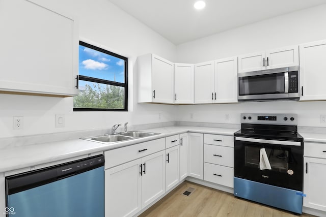 3455 N Illinois St, Indianapolis, IN 46208 - kitchen featuring stainless steel microwave, electric range, dishwasher, light countertops, and white cabinets