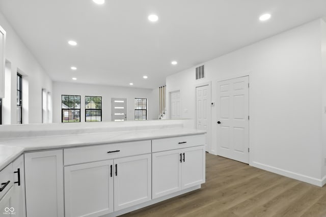 3455 N Illinois St, Indianapolis, IN 46208 - kitchen featuring white cabinetry, recessed lighting, light wood-type flooring, and light countertops