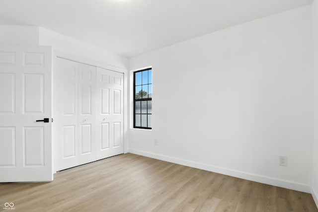 3455 N Illinois St, Indianapolis, IN 46208 - unfurnished bedroom featuring light wood finished floors and a closet
