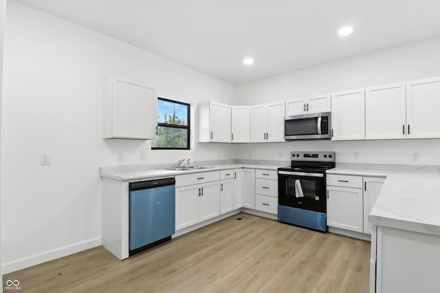 3455 N Illinois St, Indianapolis, IN 46208 - kitchen featuring stainless steel microwave, range with electric cooktop, dishwasher, light wood finished floors, and light countertops