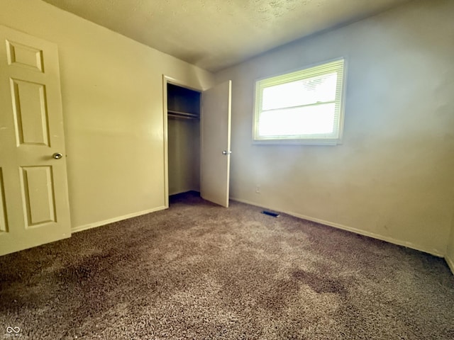 3034 E 35th St, Indianapolis, IN 46218 - unfurnished bedroom with carpet flooring and a closet