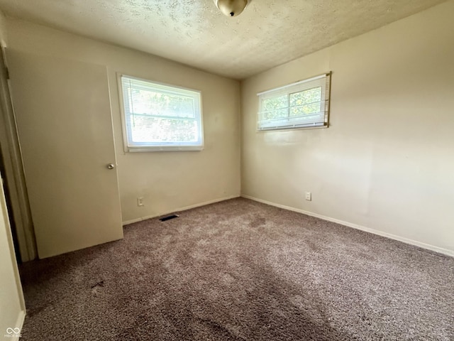 3034 E 35th St, Indianapolis, IN 46218 - carpeted spare room featuring a textured ceiling and baseboards
