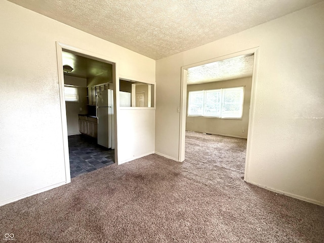 3034 E 35th St, Indianapolis, IN 46218 - unfurnished room with dark colored carpet and a textured ceiling