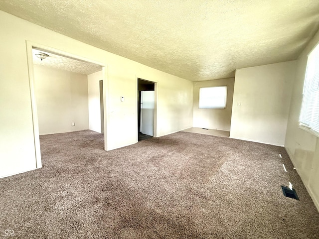 3034 E 35th St, Indianapolis, IN 46218 - unfurnished room with a textured ceiling and carpet flooring