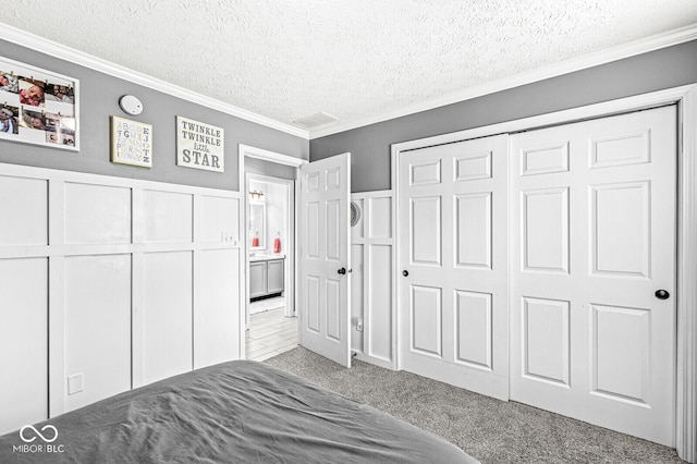 577 Austrian Way, Avon, IN 46123 - carpeted bedroom with crown molding, a textured ceiling, a decorative wall, and a closet