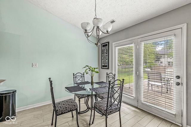 577 Austrian Way, Avon, IN 46123 - dining room featuring a chandelier, a textured ceiling, and wood tiled floors