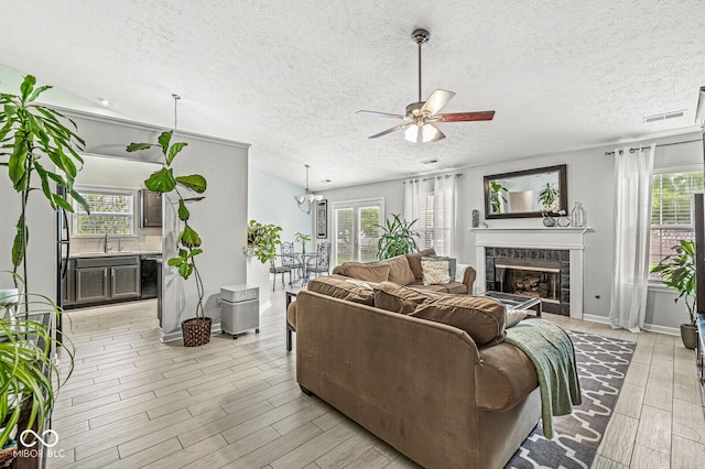 577 Austrian Way, Avon, IN 46123 - living room with ceiling fan, healthy amount of natural light, a premium fireplace, and a textured ceiling