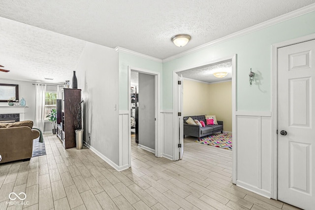 577 Austrian Way, Avon, IN 46123 - hall with a textured ceiling, light wood-style floors, a wainscoted wall, and ornamental molding
