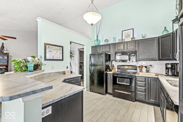 577 Austrian Way, Avon, IN 46123 - kitchen featuring black appliances, a peninsula, backsplash, light stone countertops, and washer / dryer