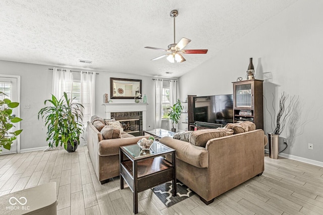 577 Austrian Way, Avon, IN 46123 - living room with ceiling fan, a textured ceiling, light wood-style flooring, and a glass covered fireplace
