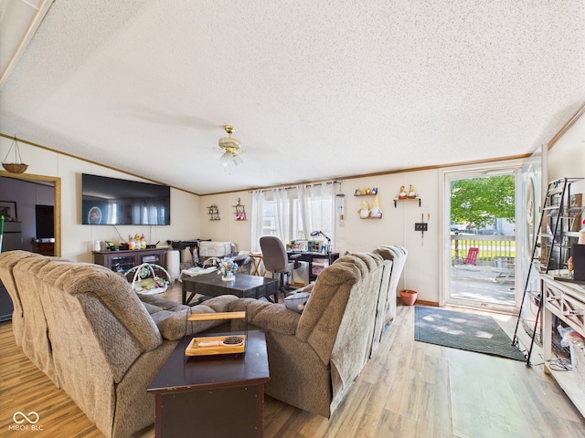 401 S Fletcher St, Frankton, IN 46044 - living room featuring a textured ceiling, wood finished floors, ceiling fan, vaulted ceiling, and healthy amount of natural light