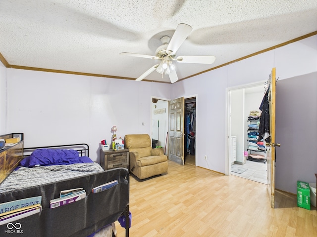 401 S Fletcher St, Frankton, IN 46044 - bedroom with ornamental molding, light wood-type flooring, a ceiling fan, a textured ceiling, and a closet