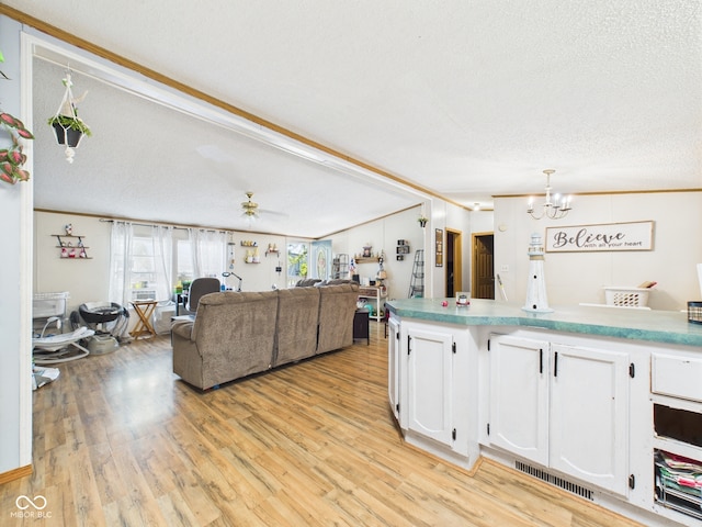 401 S Fletcher St, Frankton, IN 46044 - kitchen featuring white cabinetry, open floor plan, light wood finished floors, a chandelier, and ornamental molding