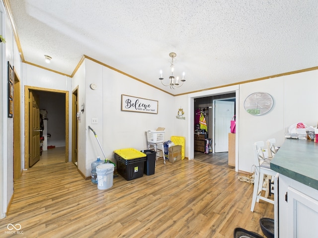 401 S Fletcher St, Frankton, IN 46044 - dining space featuring ornamental molding, light wood-style flooring, a chandelier, and a textured ceiling