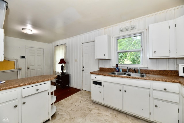 8921 E 21st St, Indianapolis, IN 46219 - kitchen featuring healthy amount of natural light, white cabinetry, and dark countertops