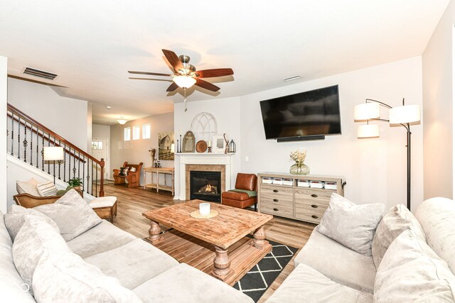 6819 Park Grove Blvd, Whitestown, IN 46075 - living area with a ceiling fan, stairs, wood finished floors, and a fireplace