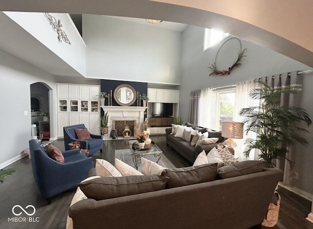16424 Brookhollow Dr, Noblesville, IN 46062 - living room with arched walkways, a high end fireplace, wood finished floors, and a towering ceiling