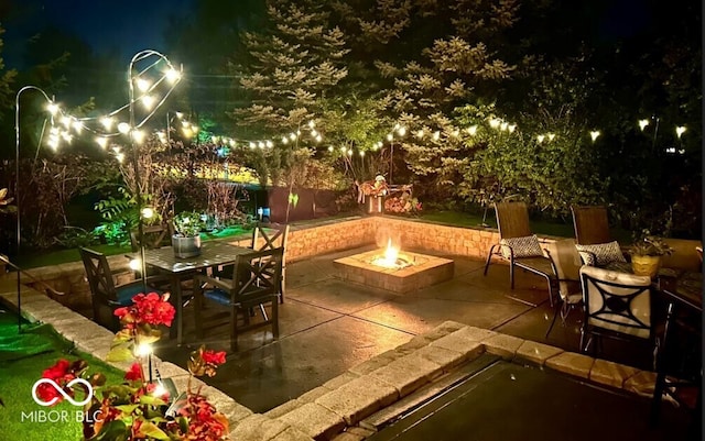 16424 Brookhollow Dr, Noblesville, IN 46062 - patio at night featuring an outdoor fire pit, a patio area, and outdoor dining area