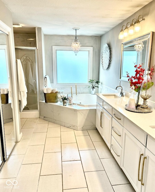 16424 Brookhollow Dr, Noblesville, IN 46062 - bathroom featuring a garden tub, double vanity, a stall shower, tile patterned floors, and a chandelier
