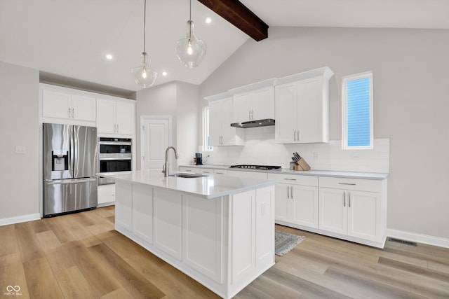 15744 Kohut Ln, Westfield, IN 46074 - kitchen with stainless steel appliances, under cabinet range hood, backsplash, light wood-type flooring, and light countertops
