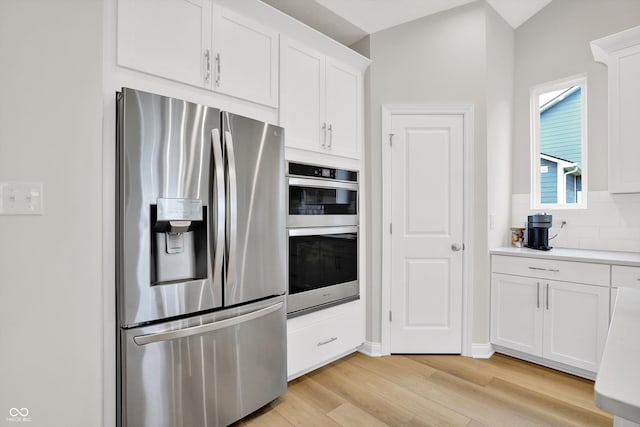15744 Kohut Ln, Westfield, IN 46074 - kitchen with stainless steel appliances, light wood-type flooring, white cabinetry, backsplash, and light countertops