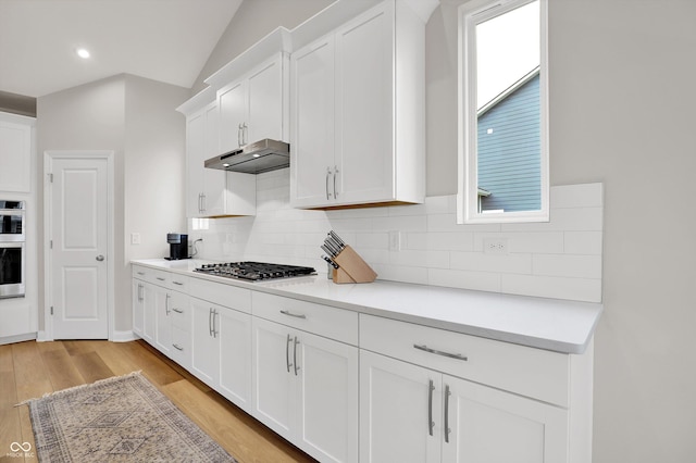 15744 Kohut Ln, Westfield, IN 46074 - kitchen featuring under cabinet range hood, white cabinetry, light wood finished floors, light countertops, and recessed lighting