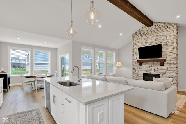 15744 Kohut Ln, Westfield, IN 46074 - kitchen with light wood-type flooring, a fireplace, stainless steel dishwasher, and open floor plan